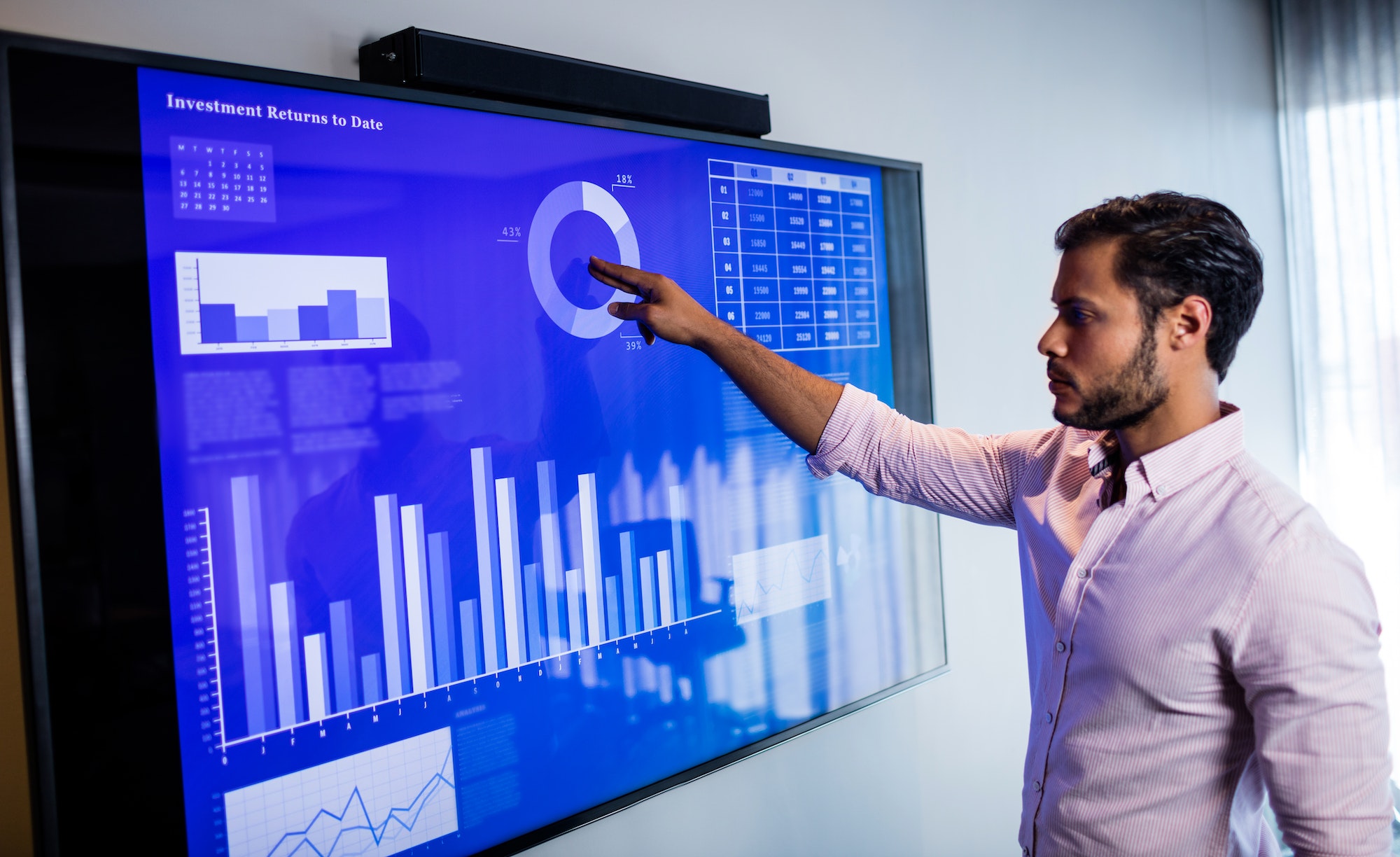 Businessman analyzing data with a touch screen